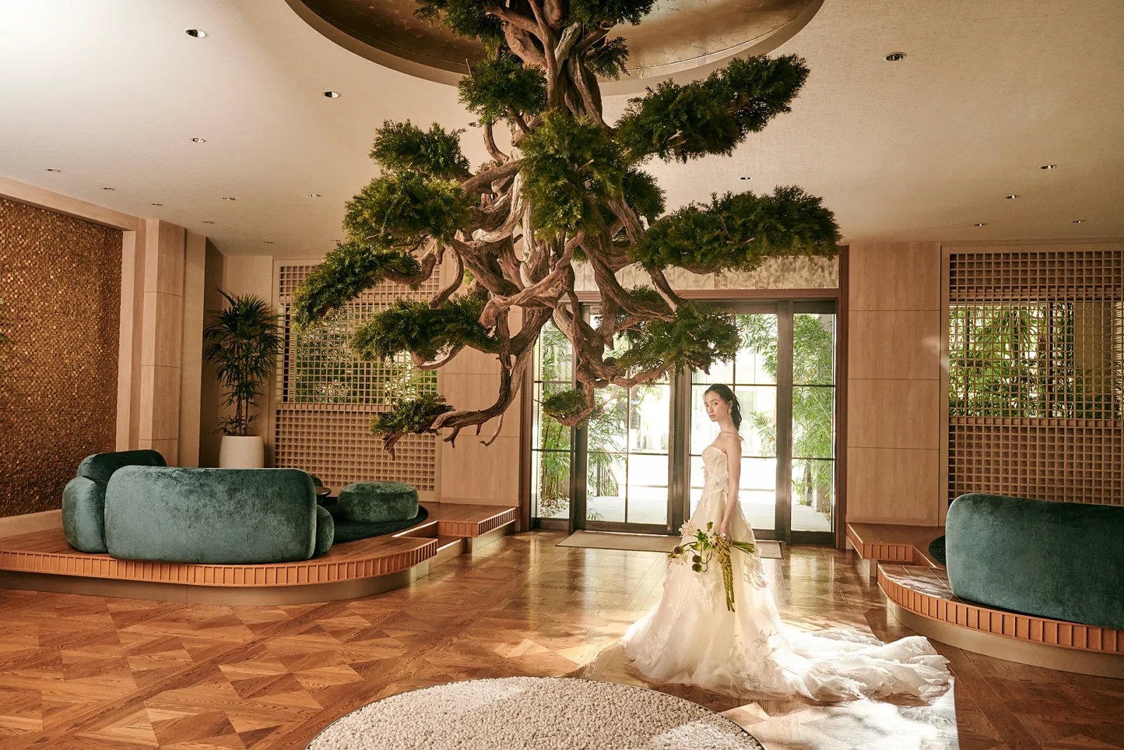 Lobby with a single tree under a high ceiling